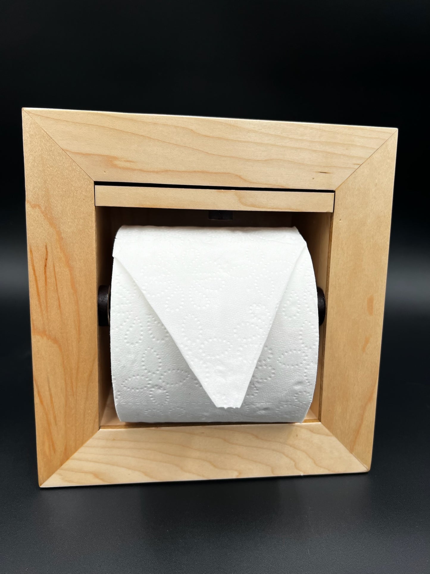 Recessed toilet tissue holder compartment.