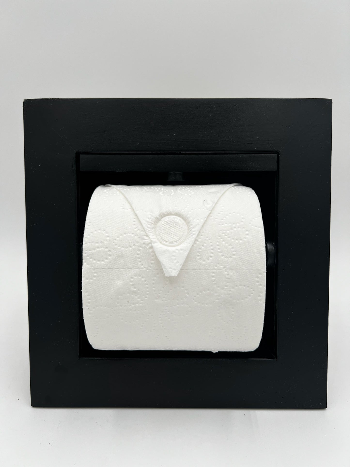 Recessed toilet tissue holder compartment.