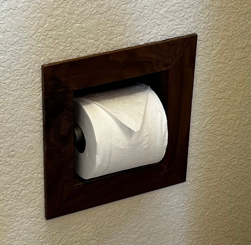 Recessed toilet tissue holder compartment.